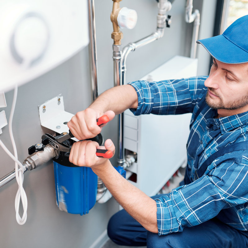 worker installing a water filtration system