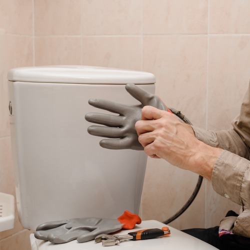 plumber repairing a toilet